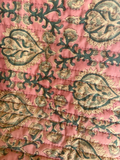 House of Mulmul - Blockprinted Cotton Hair Tool Bag. Close-up of a pink hair tool bag with intricate green and beige floral patterns
