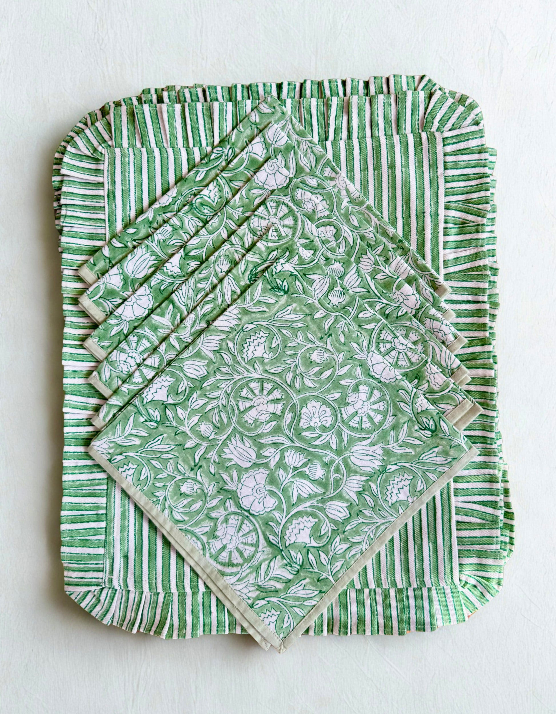 House of Mulmul - Blockprinted Cotton Placemats and Napkins. Set of green patterned placemats on a white background