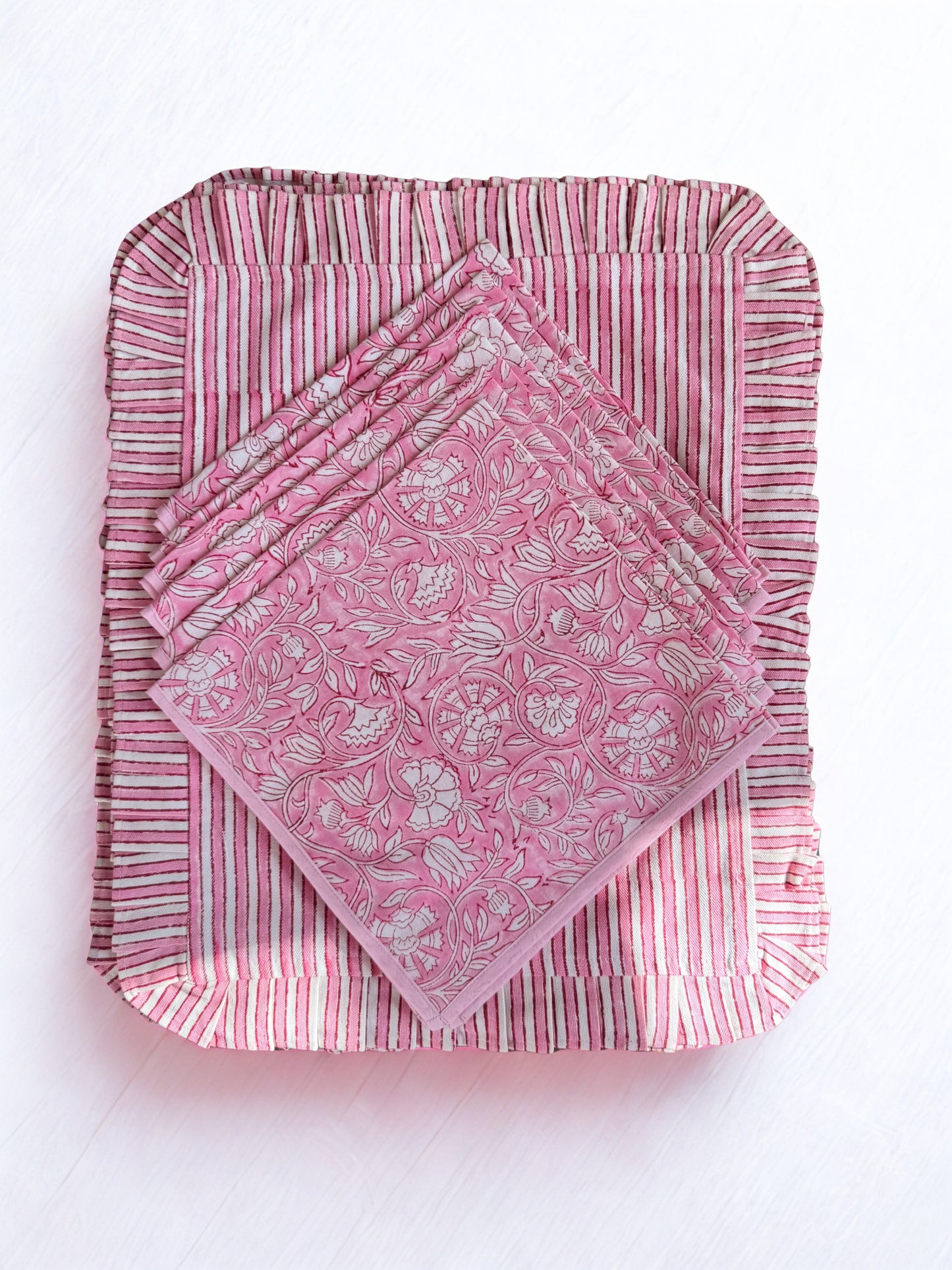 House of Mulmul - Blockprinted Cotton Placemats and Napkins. Set of pink patterned napkins on a white background