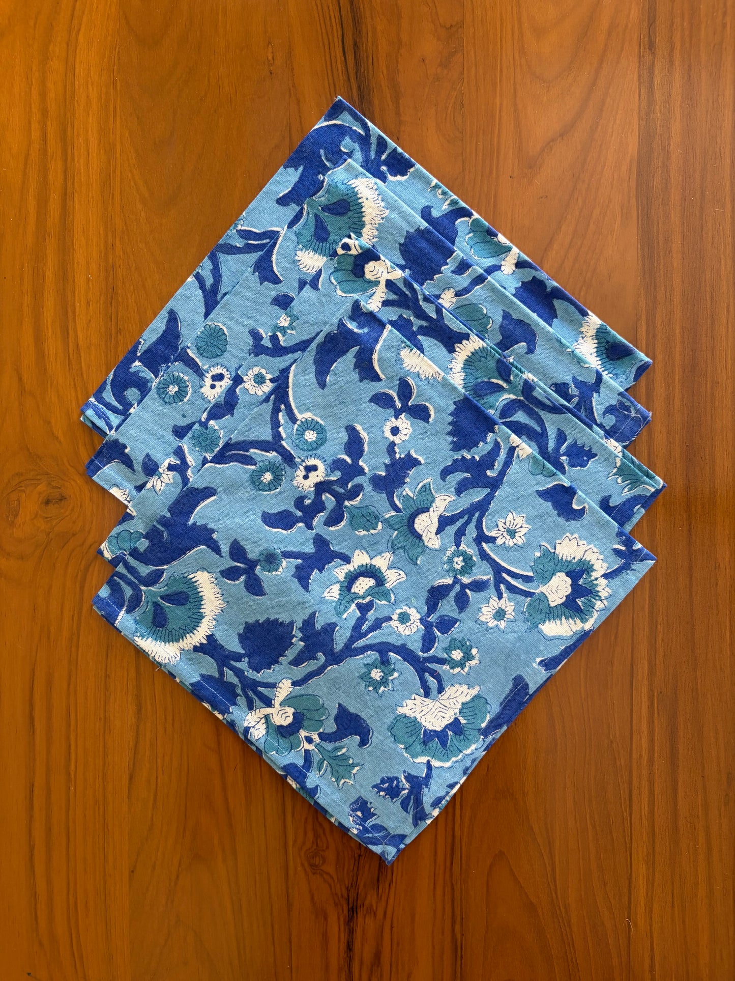 House of Mulmul - Blockprinted Cotton Table Napkins. Set of three blue patterned napkins on a wooden surface