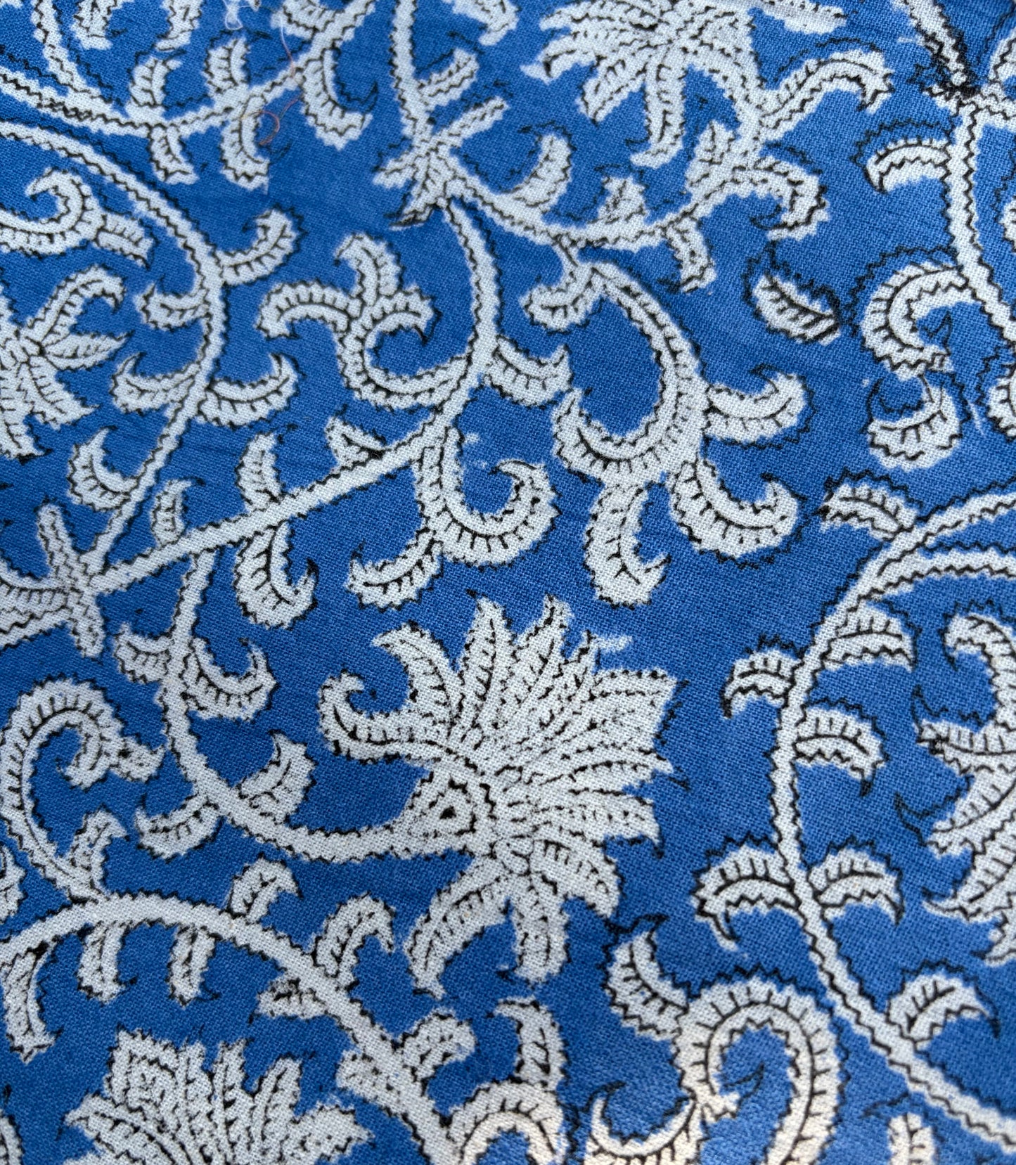 House of Mulmul - Blockprinted Cotton Table Napkins. Close-up of a blue fabric with white floral embroidery