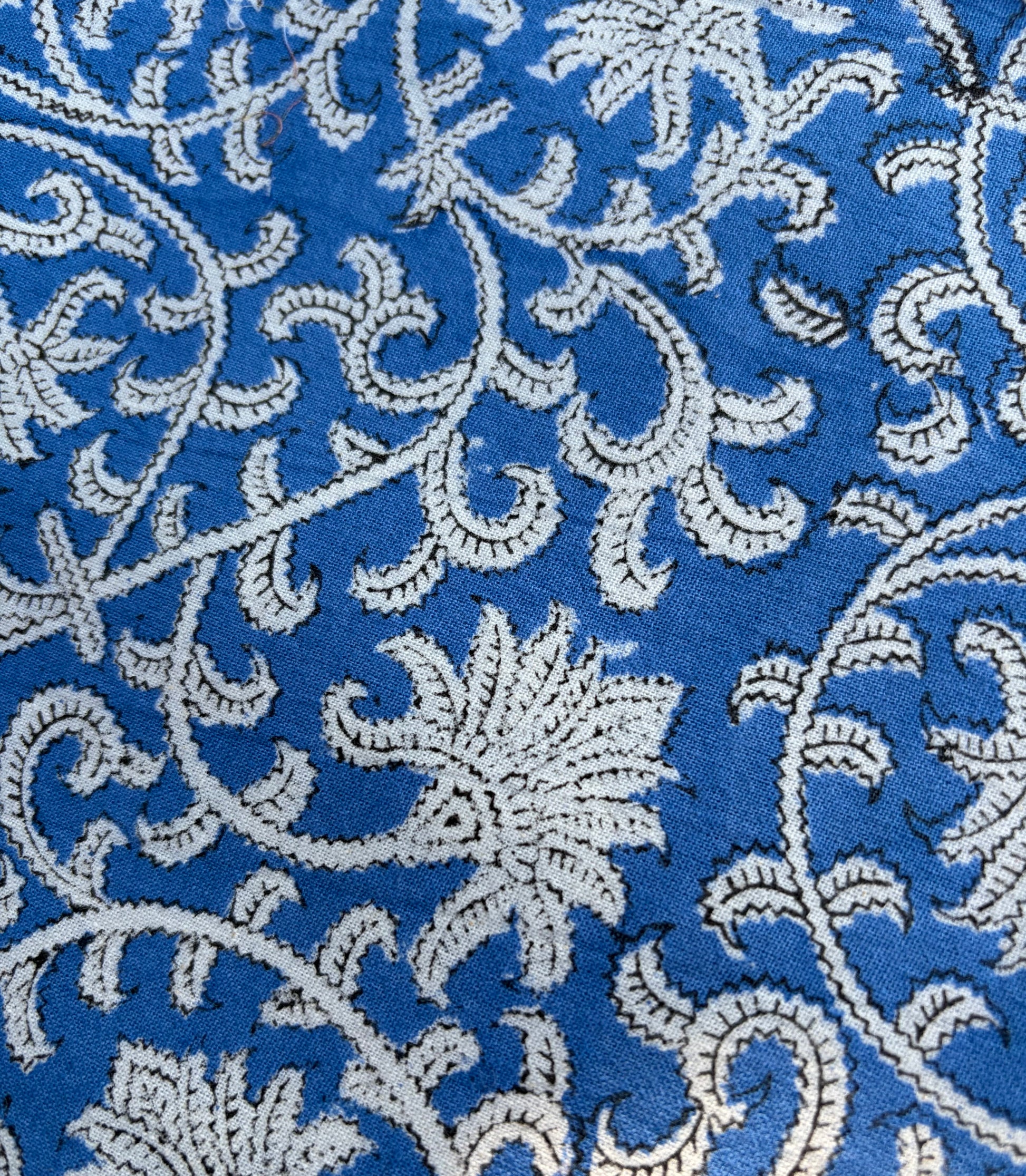 House of Mulmul - Blockprinted Cotton Table Napkins. Close-up of a blue fabric with white floral embroidery