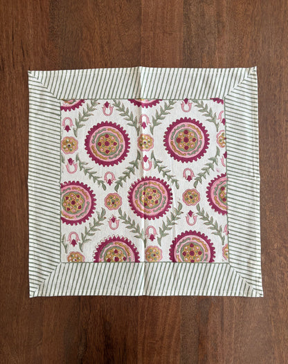 House of Mulmul_ Blockprinted Cotton Napkins. Cotton Napkins square with floral pattern on a wooden surface