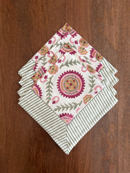 House of Mulmul_ Blockprinted Cotton Napkins. Set of floral and striped napkins on a wooden surface