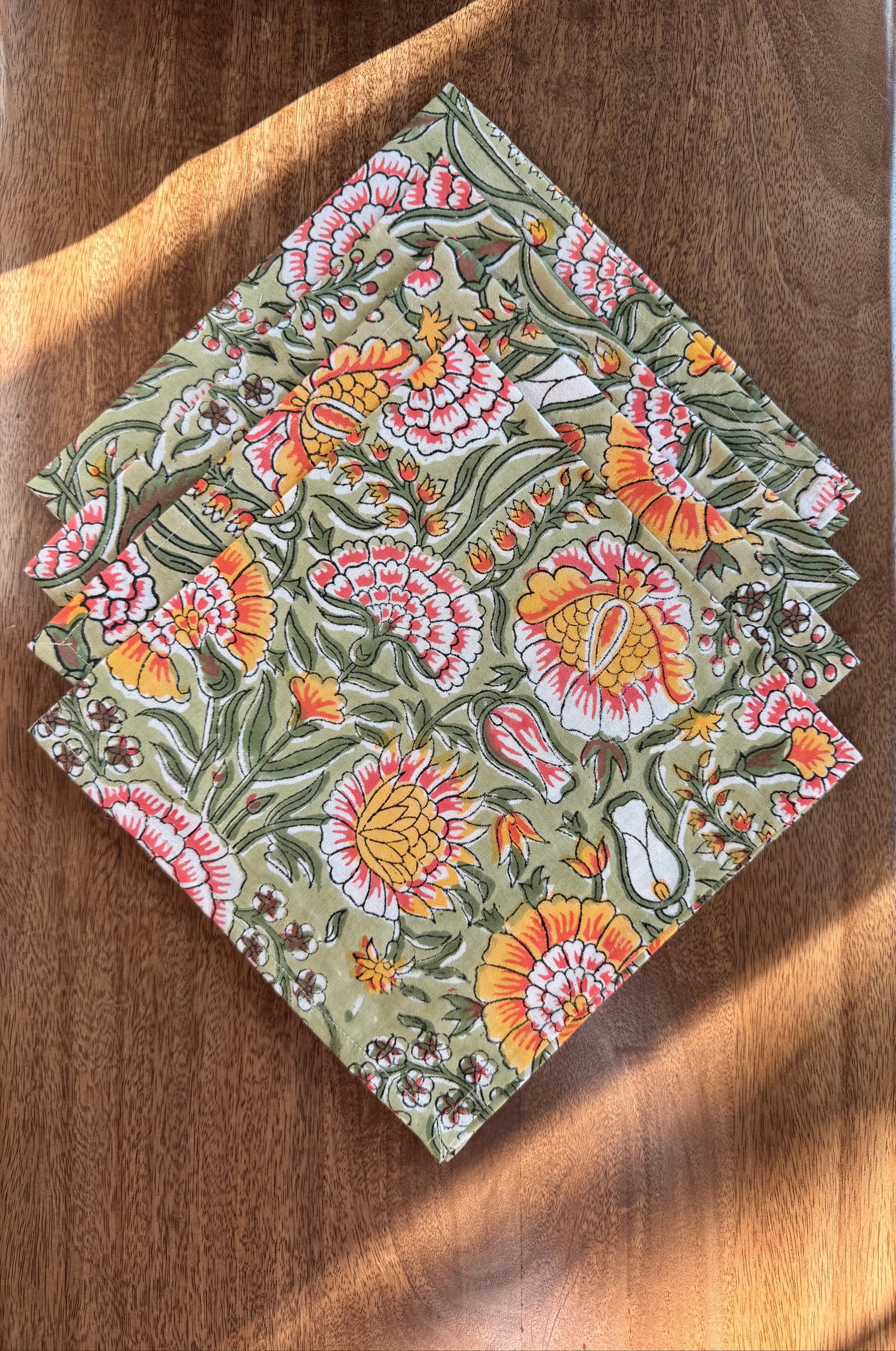 House of Mulmul - Blockprinted Cotton Napkins. Floral patterned napkins on a wooden surface