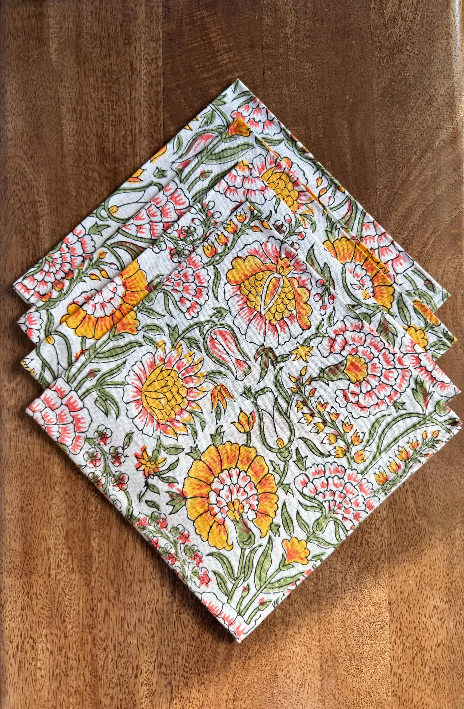 House of Mulmul - Blockprinted Cotton Napkins. Floral patterned napkins on a wooden surface