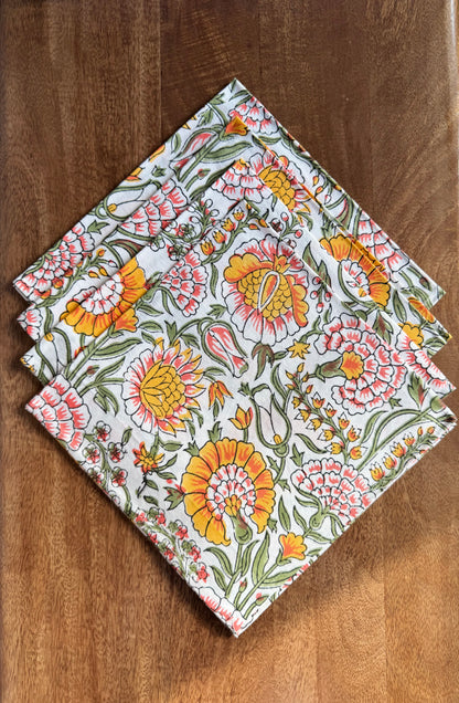House of Mulmul - Blockprinted Cotton Napkins. Floral patterned napkins on a wooden surface