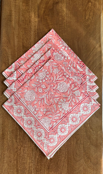 House of Mulmul - Blockprinted Cotton Napkins. Set of pink patterned napkins on a wooden surface