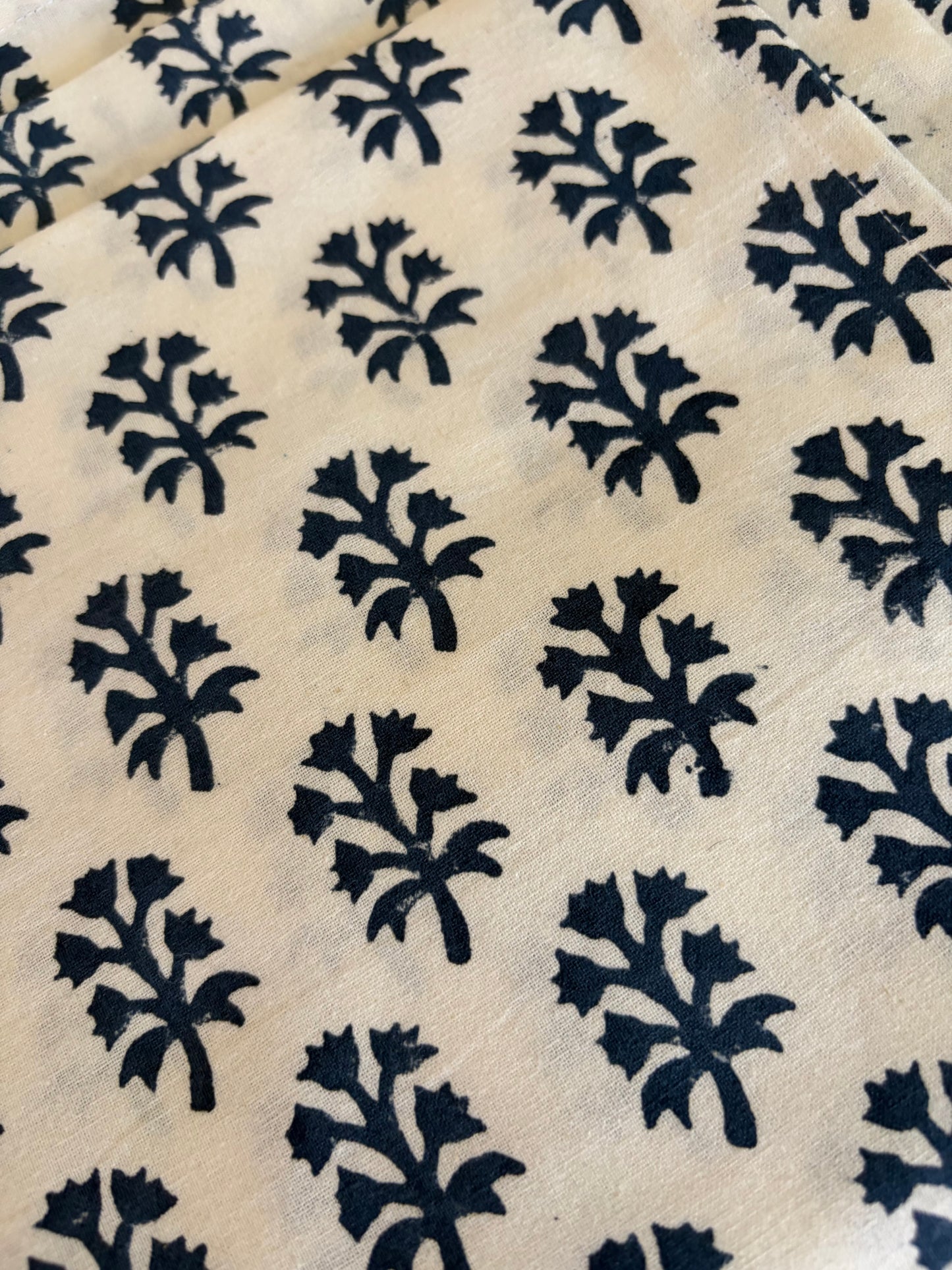 House of Mulmul - Blockprinted Cotton Table Napkins. Patterned fabric with blue and black floral designs on a white background