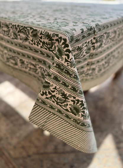 House of Mulmul - Blockprinted Cotton Table Cloth. Cotton tablecloth with green and white colors and flowers. Decorative tablecloth with intricate patterns on a table