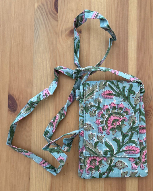 House of Mulmul - Blockprinted Crossbody Mobile Sling Bag. Floral patterned mobile pouch with strap on a wooden surface