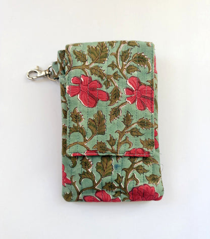 House of Mulmul - Blockprinted Mobile Sling Bag. A small fabric phone holder or wallet with a floral print, featuring red flowers and brown leaves on a light green background, with a silver metal clasp on the left side.
