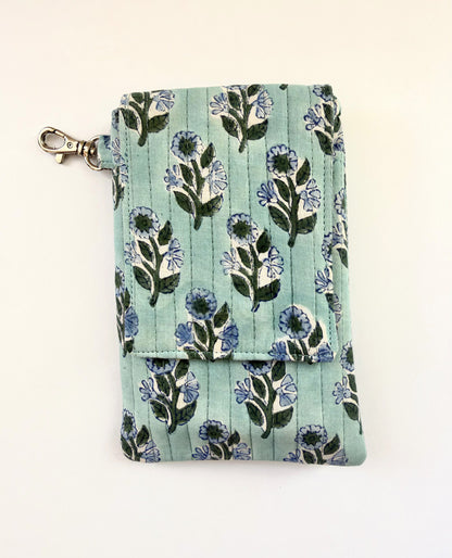 House of Mulmul - Blockprinted Mobile Sling Bag. A mint green blue quilted fabric pouch with a blue and green floral block print, featuring a silver metal clasp on the left side, photographed on a plain off-white background.
