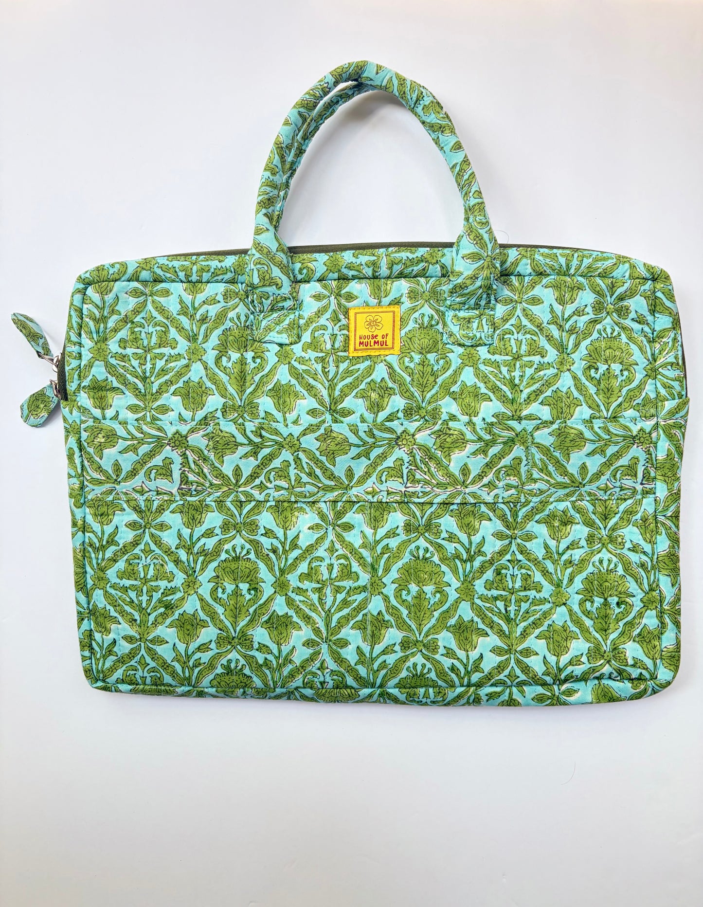 House of Mulmul - Blockprinted Cotton Quilted Laptop Bag. A quilted fabric laptop sleeve featuring a green and turquoise floral damask pattern, with two top handles and a small yellow brand label on the front.