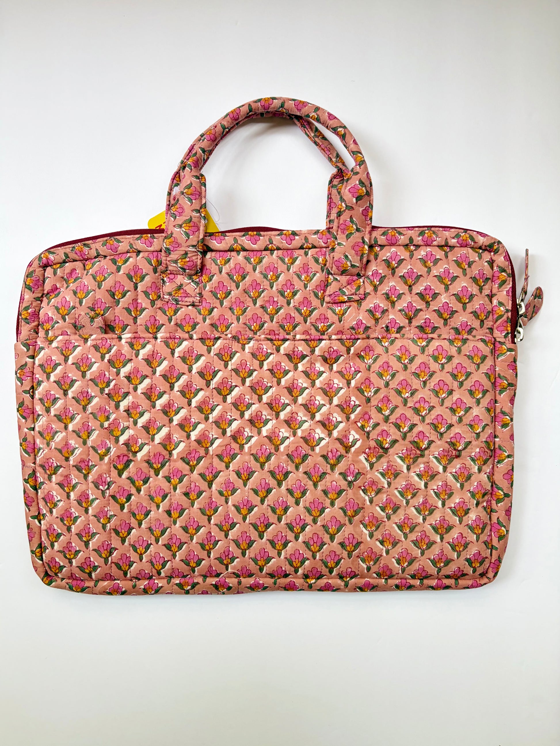 House of Mulmul - Blockprinted Cotton Quilted Laptop Bag. A quilted laptop bag in pink and beige floral fabric with a diamond-quilted pattern and top handles, shown against a plain white background.
