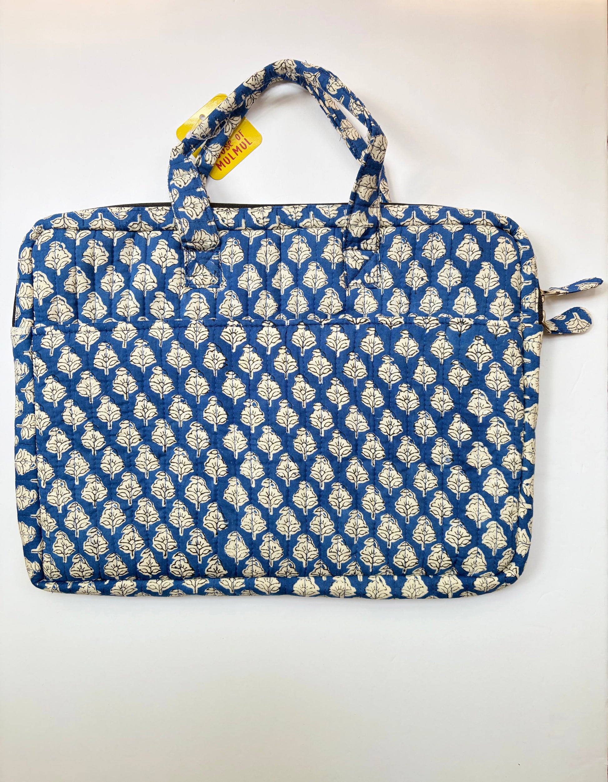 House of Mulmul - Blockprinted Cotton Quilted Laptop Bag. A quilted fabric laptop sleeve featuring a blue and cream block-printed pattern, shown flat against a plain white background with a yellow tag attached.
