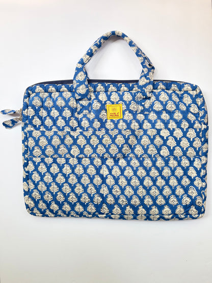 House of Mulmul - Blockprinted Cotton Quilted Laptop Bag. A quilted laptop sleeve featuring a blue and off-white block print pattern, with a small yellow brand label on the front.