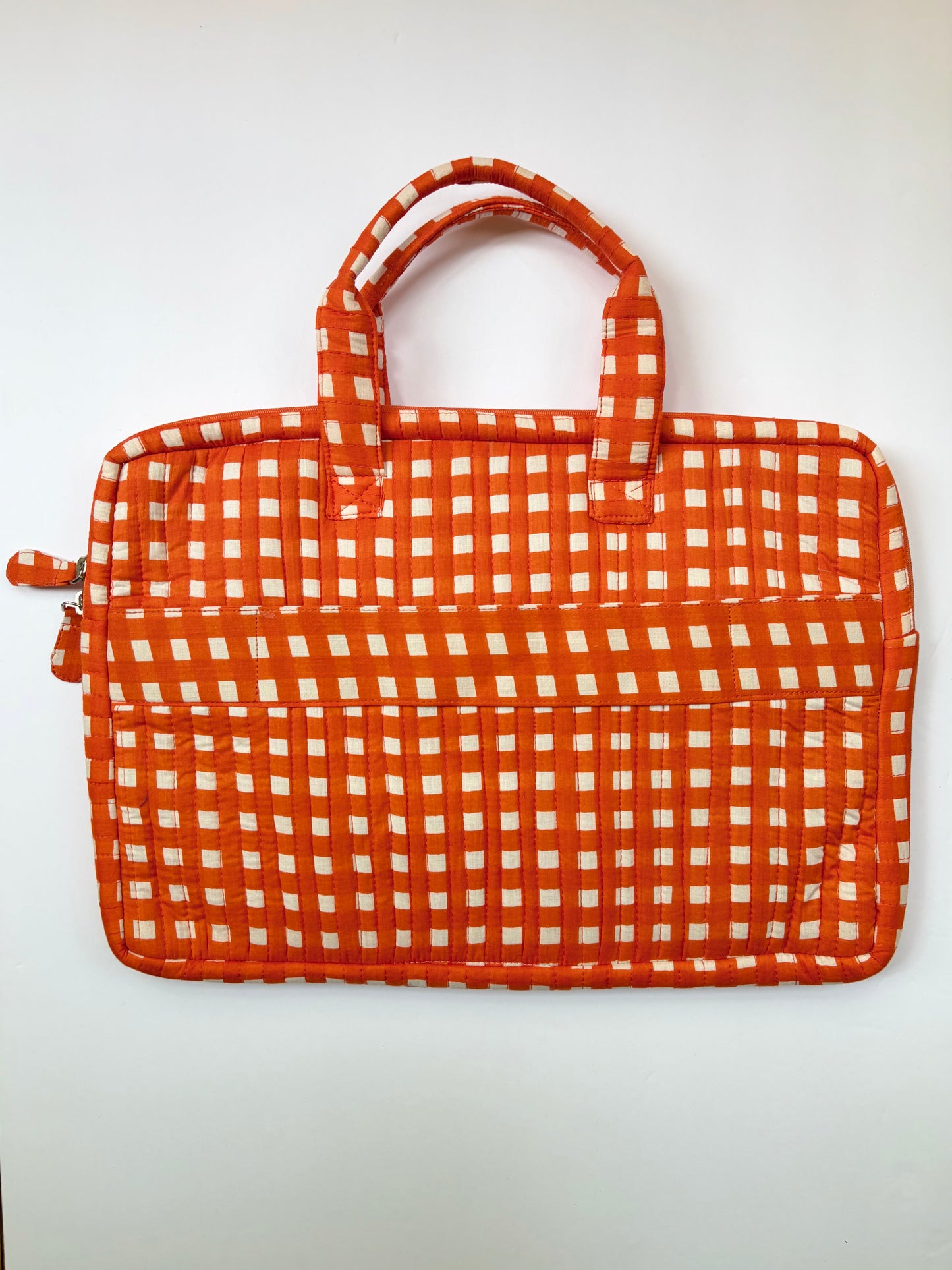 House of Mulmul - Blockprinted Cotton Quilted Laptop Bag. An orange and white gingham patterned laptop sleeve with dual top handles, shown against a plain white background.