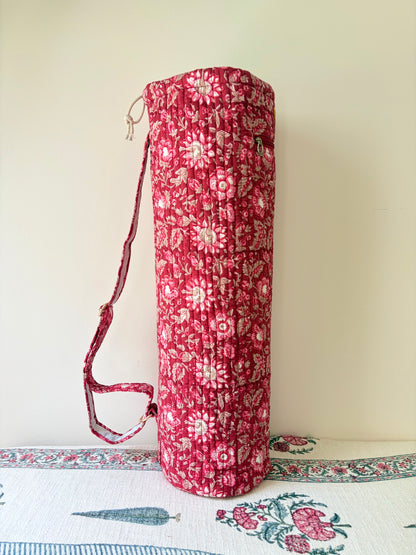 House of Mulmul - Blockprinted Yoga Mat Cover. Red floral-patterned yoga bag with a strap on a light background