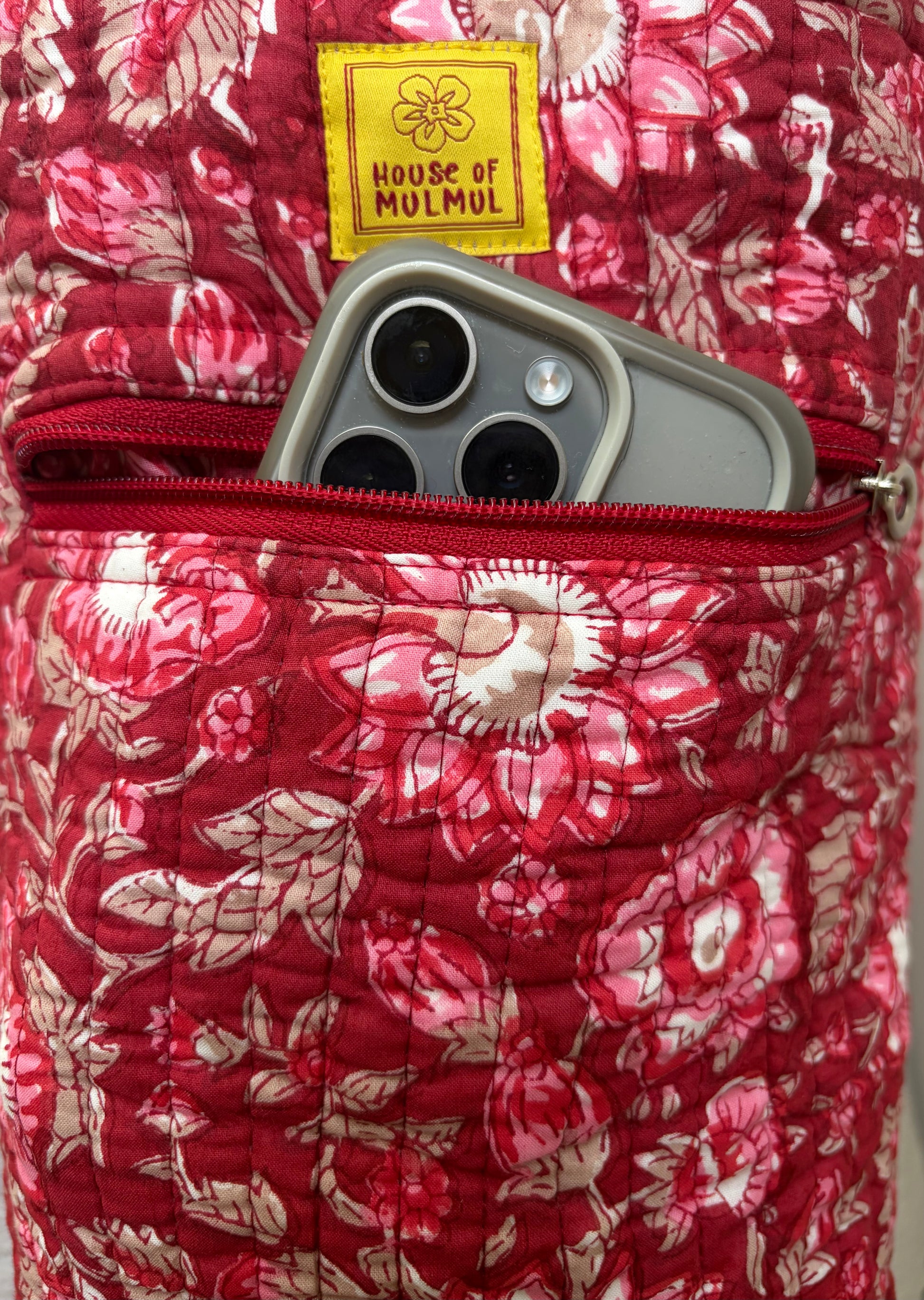 House of Mulmul - Blockprinted Yoga Mat Cover. Floral-patterned yoga mat bag with a phone inside, featuring 'House of Mulmul' branding.