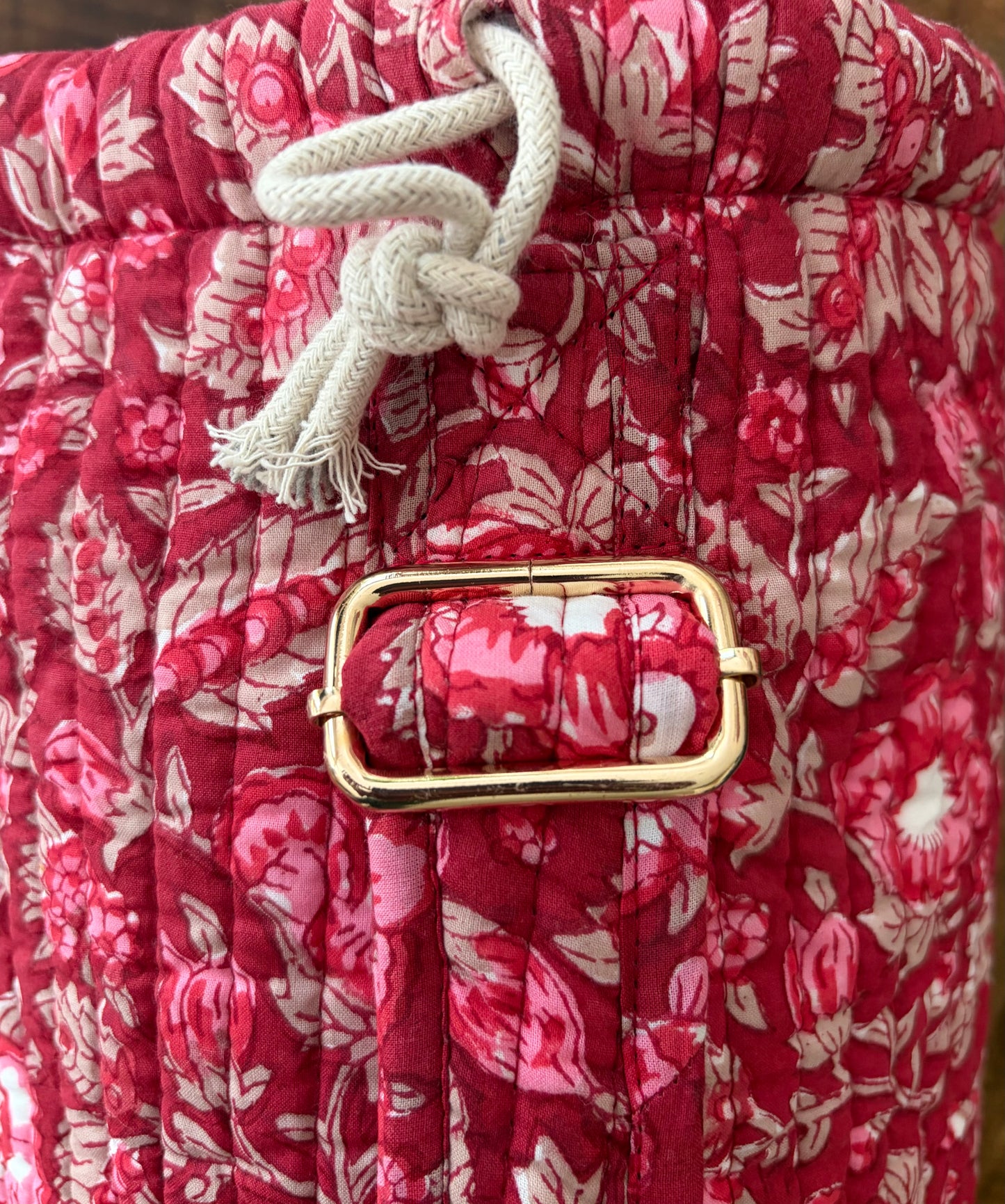 House of Mulmul - Blockprinted Yoga Mat Cover. Red floral-patterned yoga mat bag with a gold buckle and white drawstring.