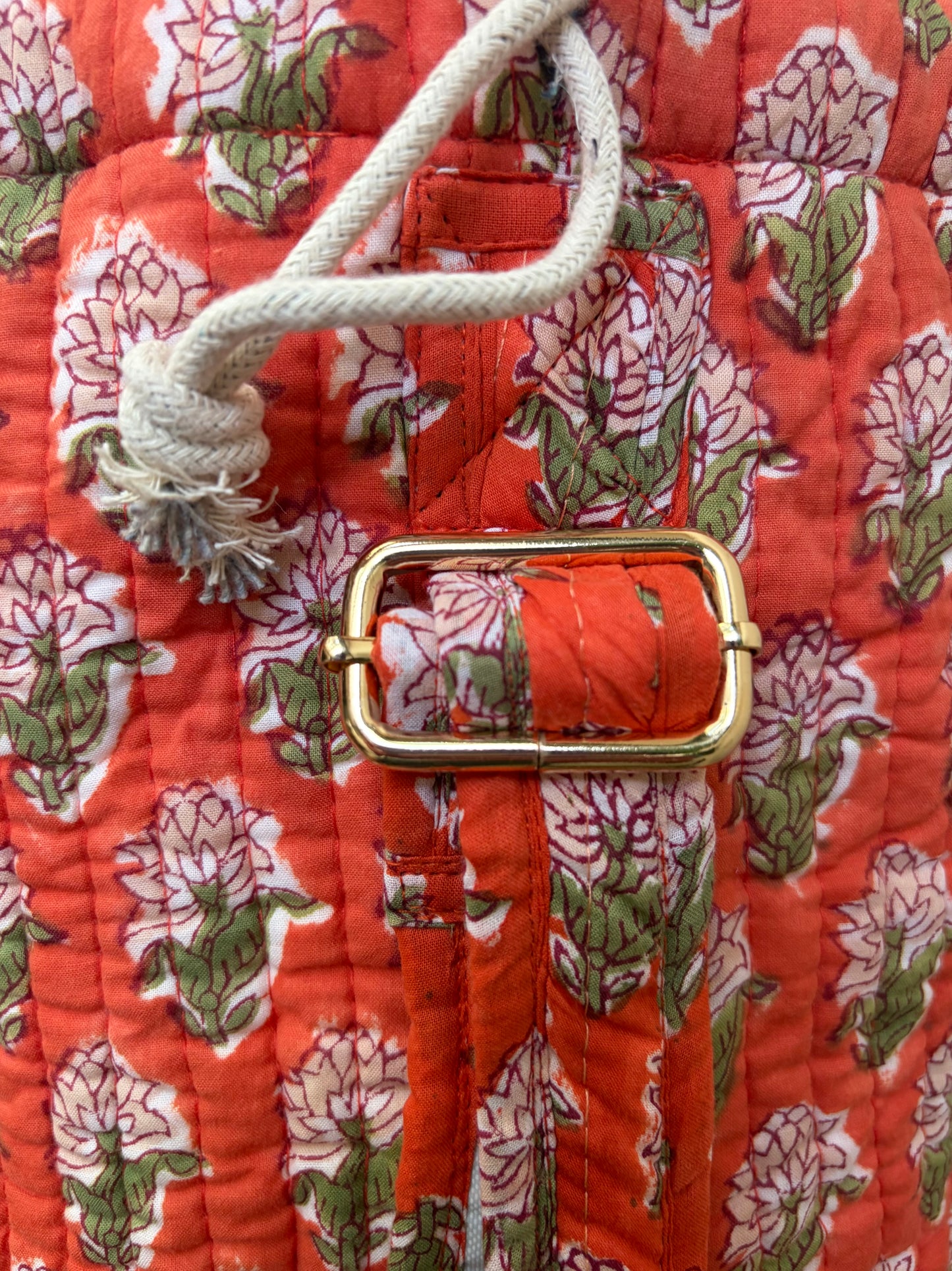 House of Mulmul - Blockprinted Yoga Mat Cover. Floral-patterned yoga mat bag on a light background. Close-up of a floral-patterned yoga bag with a gold buckle and white rope handle.