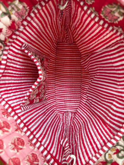 House of Mulmul - Bucket Tapered Tote Bag. Close-up of a red and white striped fabric interior with a floral patterned pocket and matching red and white striped lining.