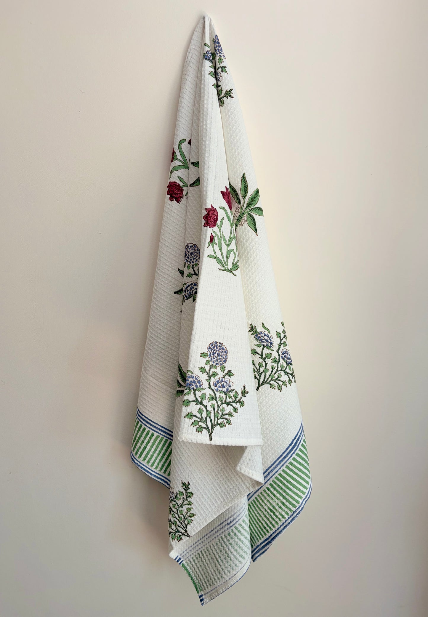 House of Mulmul - Cotton Bath and Hand Towel set. White towel with floral print on a beige background