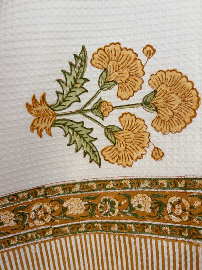 House of Mulmul - Cotton Bath Towel. Close-up of floral design on towel with a striped border.