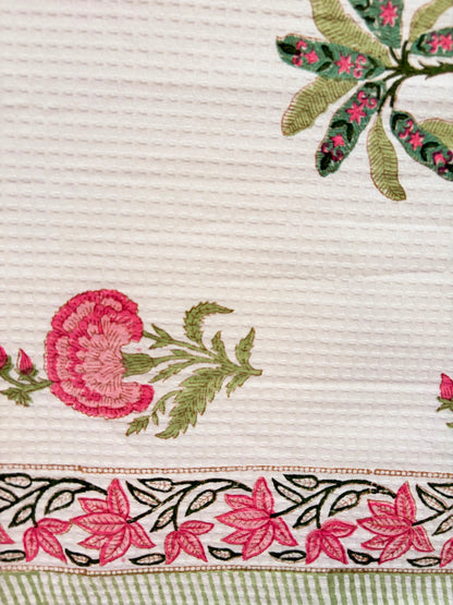 House of Mulmul - Cotton Bath and Hand Towel set. Close-up of cotton towel with floral patterns on a beige background