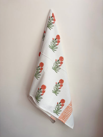 House of Mulmul - Cotton Bath and Hand Towel set. Floral patterned towel hanging on a white wall