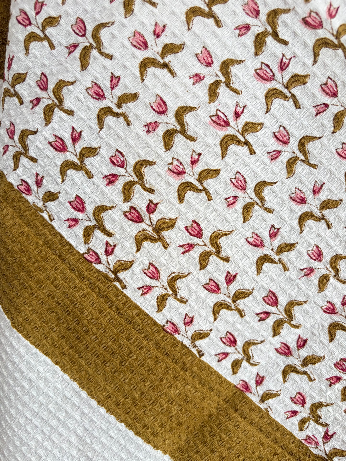 House of Mulmul - Cotton Bath and Hand Towel set. Close-up of cotton towel with floral pattern on a white background
