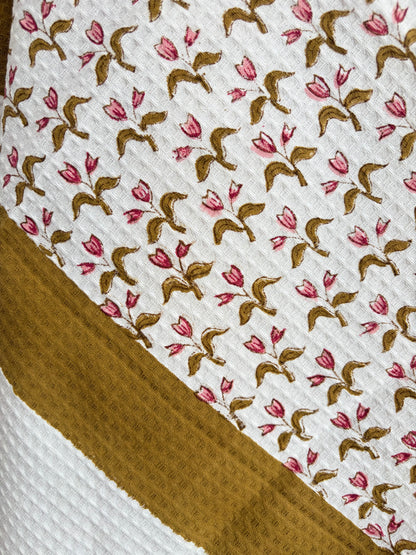 House of Mulmul - Cotton Bath and Hand Towel set. Close-up of cotton towel with floral pattern on a white background