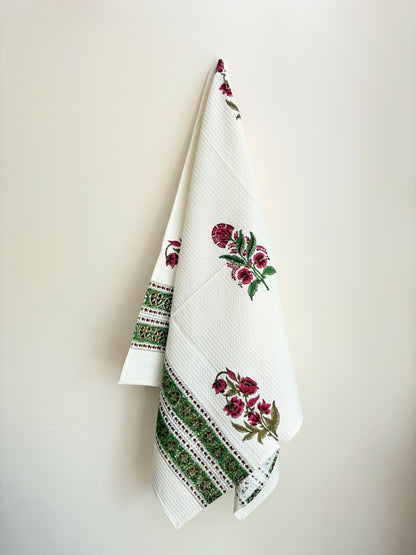 House of Mulmul - Cotton Bath Towel. Decorative towel with floral and geometric patterns on a plain background