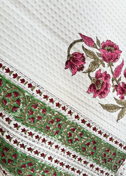 House of Mulmul - Cotton Bath Towel. Close-up of embroidered towel with floral patterns on a white background