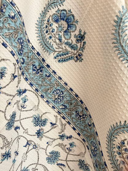 House of Mulmul - Cotton Bath Towel. Close-up of a decorative cotton towel with blue floral patterns on a white fabric