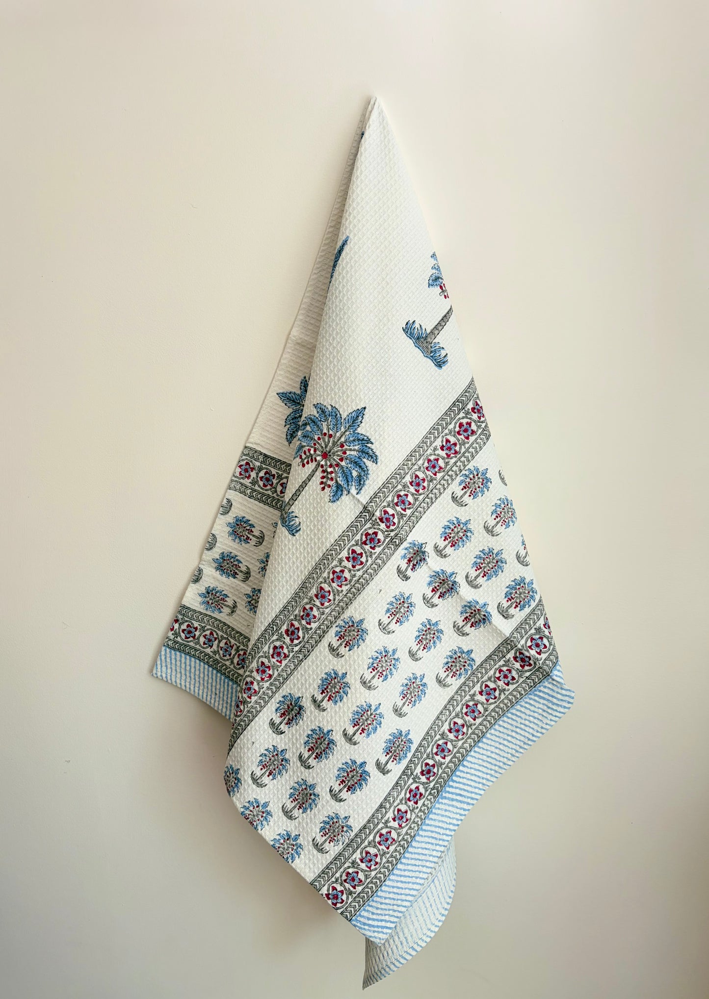 House of Mulmul - Cotton Bath Towel. Decorative towel with floral and geometric patterns on a beige background