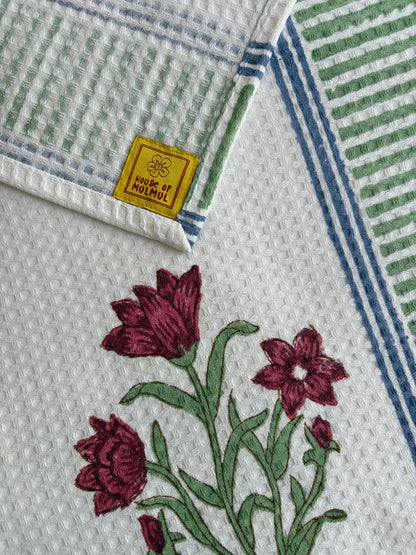 House of Mulmul - Cotton Bath and Hand Towel set. Cotton towel with floral and leaf patterns on a white background