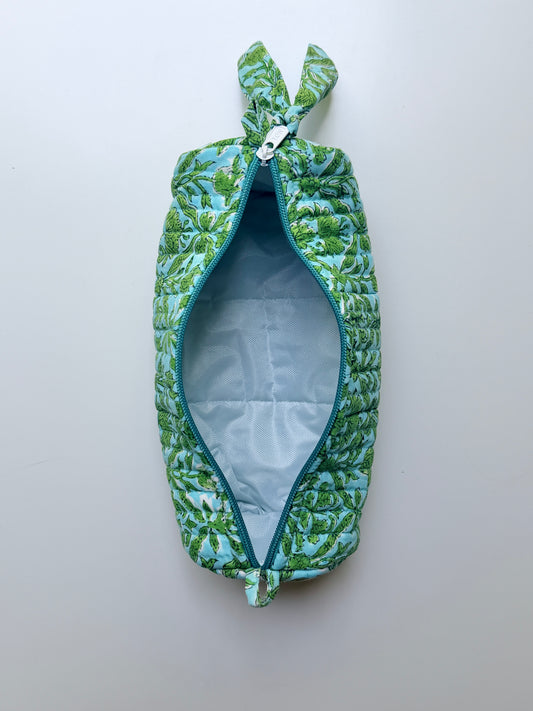 House of Mulmul - Cotton Quilted Makeup-Pencil Pouch. A zippered pouch with a green and blue tropical leaf pattern, shown open to reveal a light blue interior lining, set against a plain light gray background.