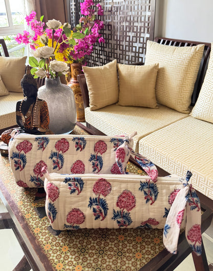 House of Mulmul - Cotton Quilted Makeup and Stationery Pouches. Decorative floral-patterned ottoman in a living room setting with a vase of flowers and pillows.