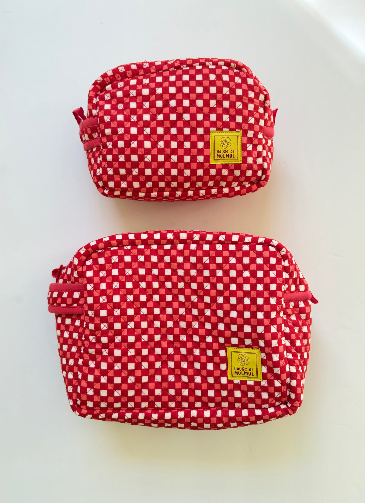 House of Mulmul - Cotton Quilted Travel Makeup Pouch set. Two red and white gingham check cosmetic pouches with yellow brand labels, displayed on a clean white background.