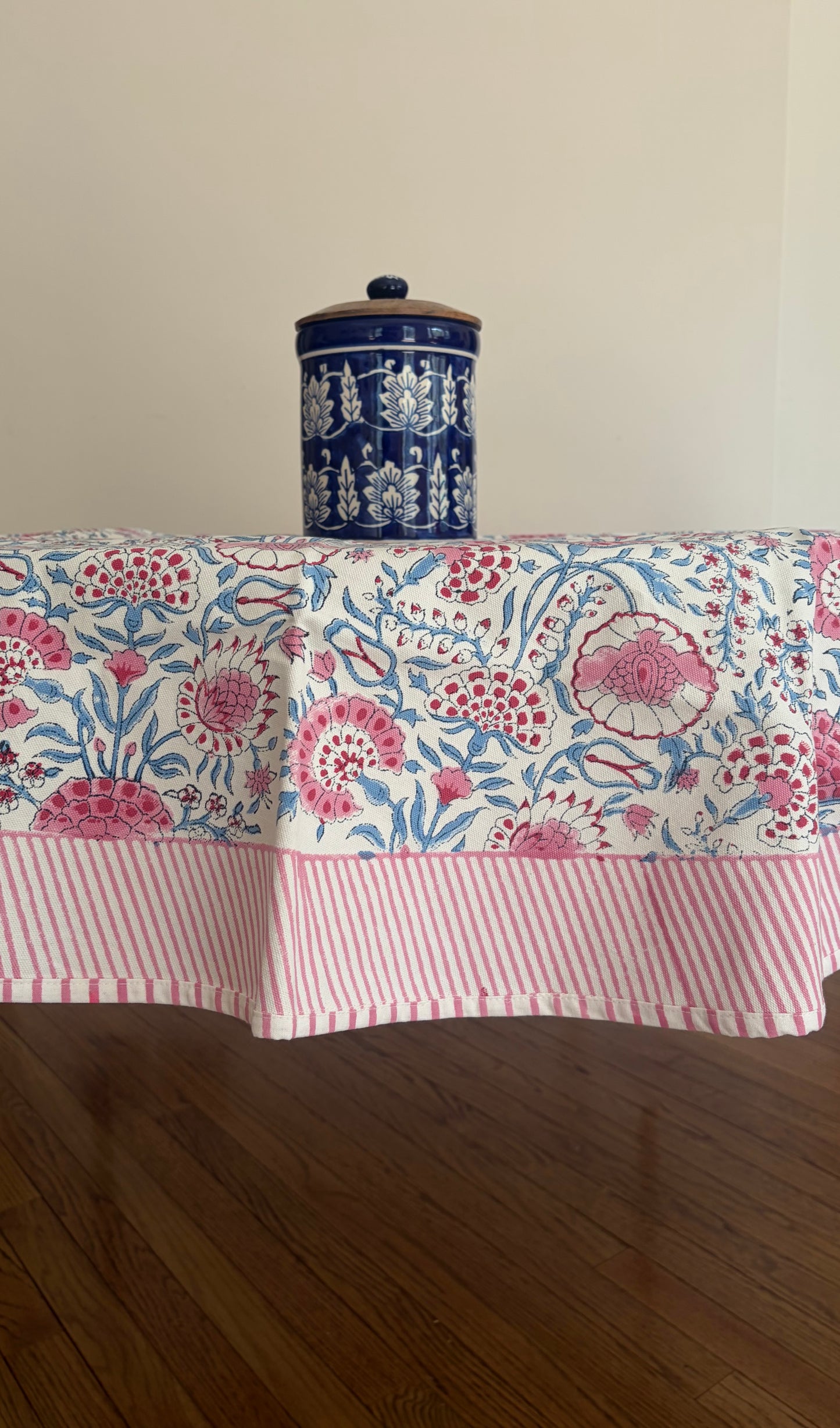 House of Mulmul - Blockprinted Cotton Table Cloth. Tablecloth with floral pattern on a wooden table