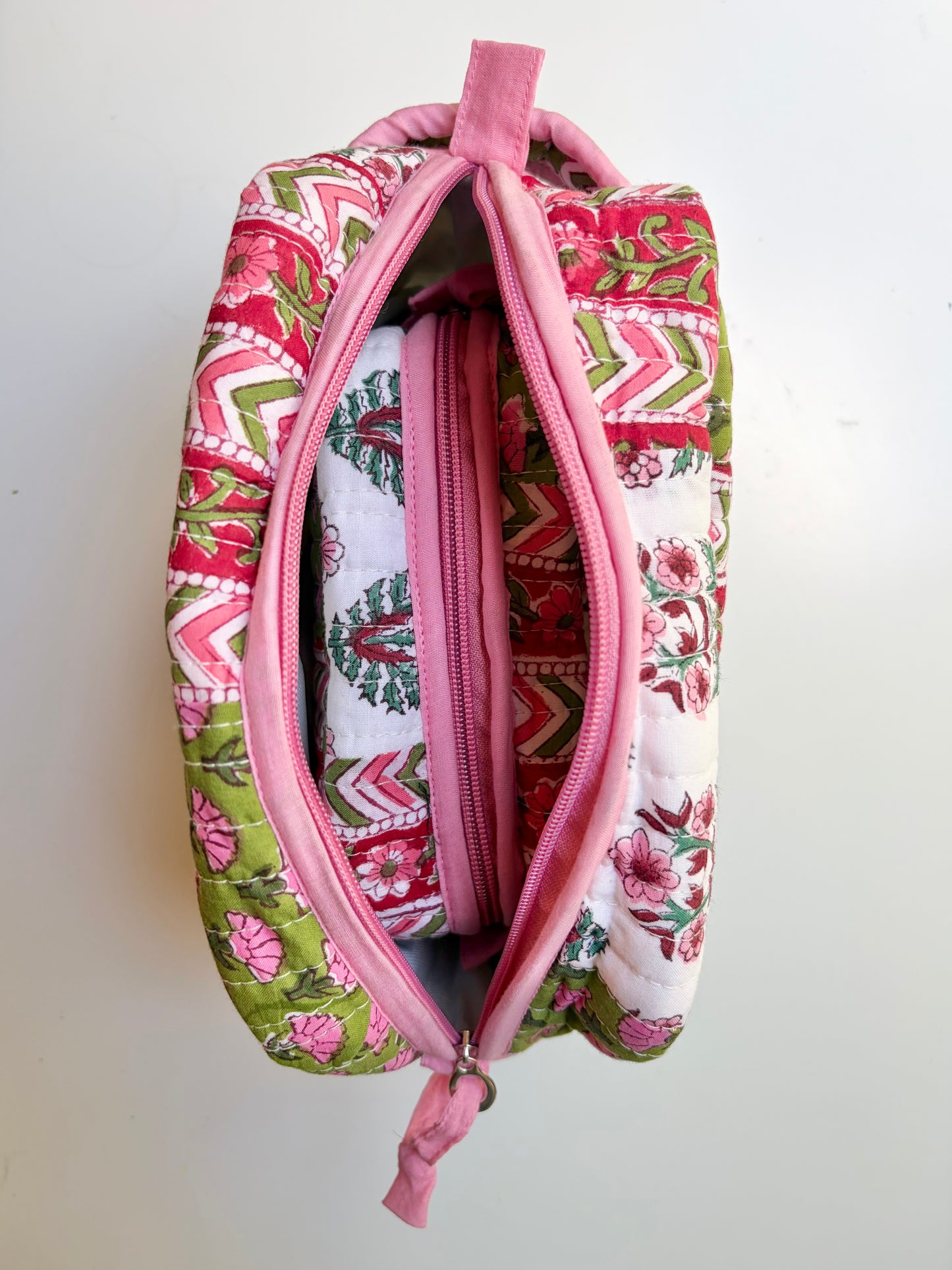 House of Mulmul - Handblock Printed Travel Makeup Quilted Pouch set. Fabric pouch with pink and green pattern on a white background