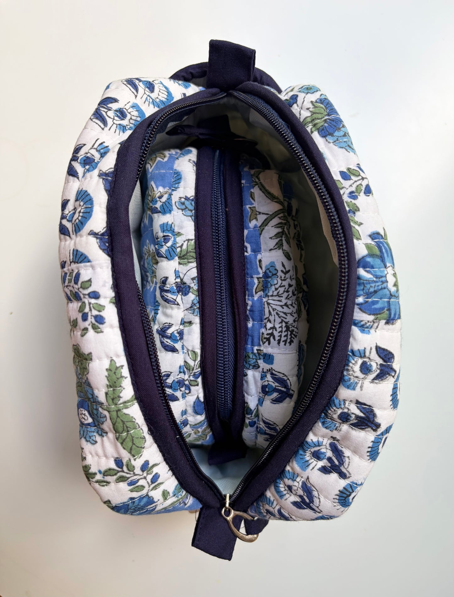 House of Mulmul - Handblock Printed Travel Makeup Quilted Pouch set. Floral-patterned fabric pouch with a zipper on a white background