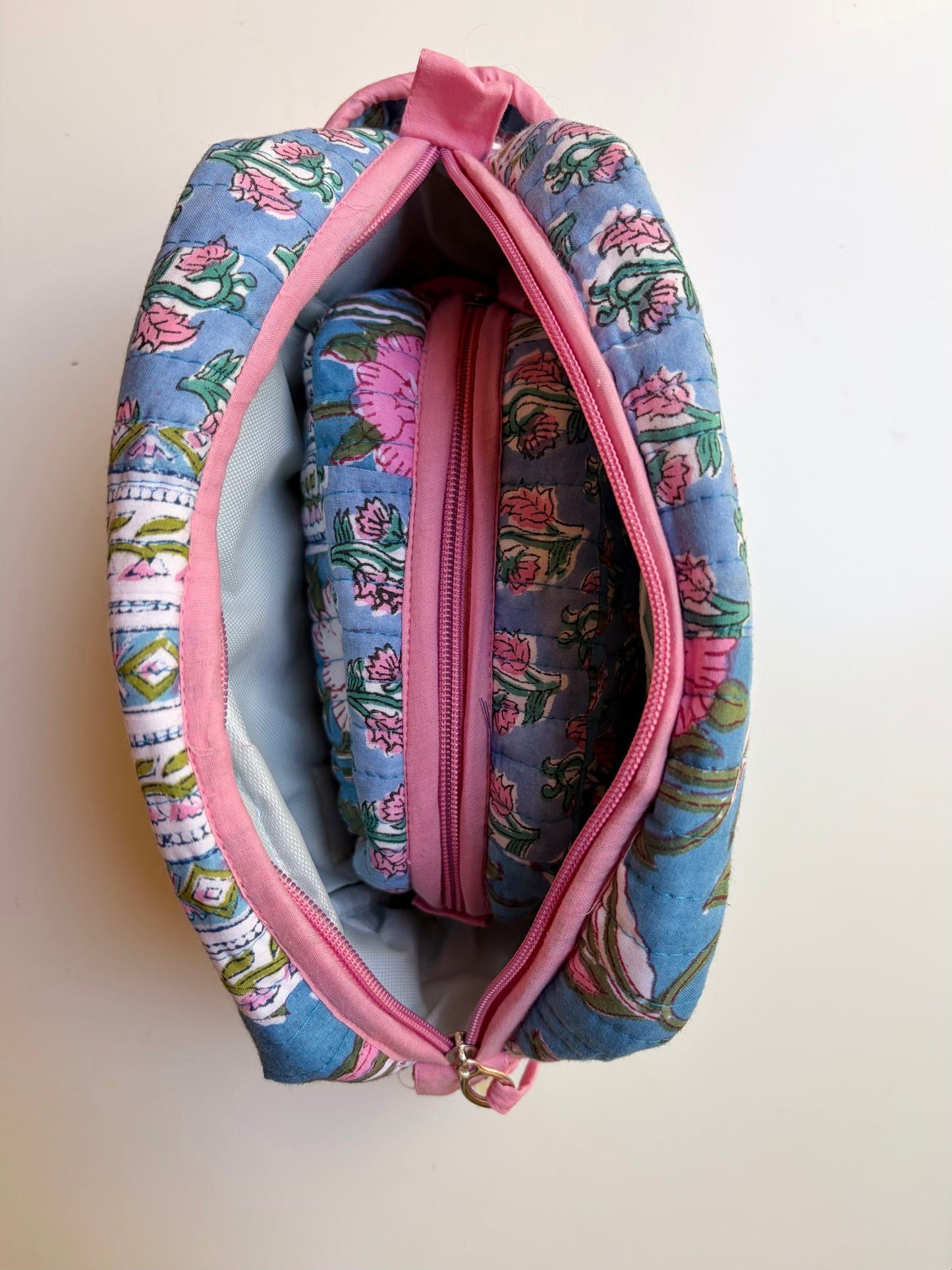 House of Mulmul - Handblock Printed Travel Makeup Quilted Pouch set. Floral-patterned makeup bag with pink zipper on a white background