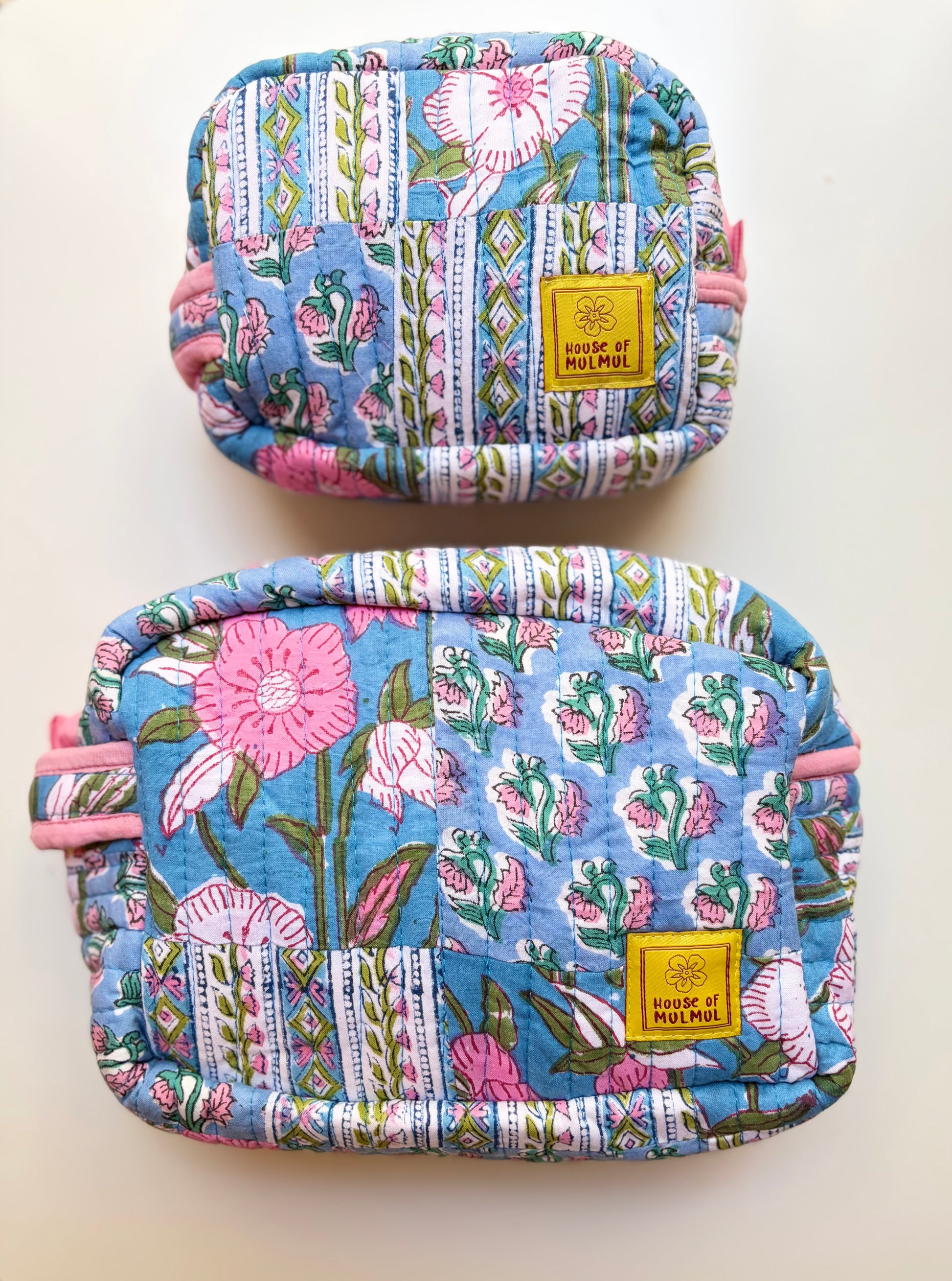 House of Mulmul - Handblock Printed Travel Makeup Quilted Pouch set. Two floral-patterned pouches with a visible brand label on a white background