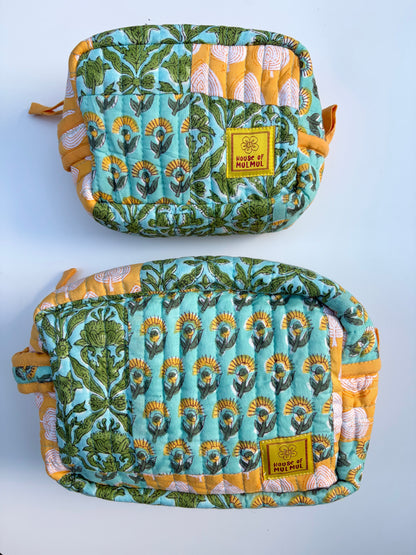 House of Mulmul - Handblock Printed Travel Makeup Quilted Pouch set. Two patterned pouches with a visible brand label on a light blue background
