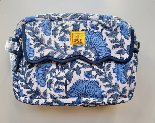 House of Mulmul - Quilted Travel Makeup pouch. Blue floral-patterned bag with a visible brand label on a wooden surface.