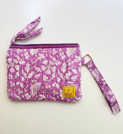 Hand Block Printed Quilted Travel Wristlet Pouch & Organizer. Purple floral-patterned pouch with matching strap on a white background
