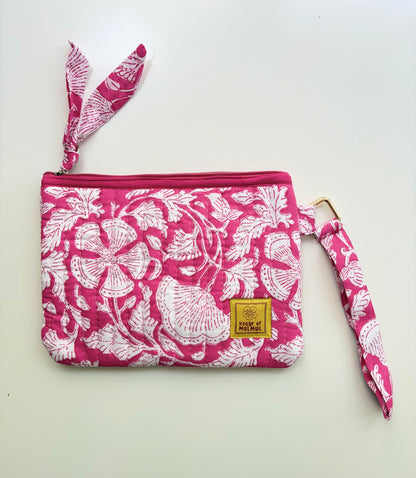 Hand Block Printed Quilted Travel Wristlet Pouch & Organizer. Pink pouch with white floral pattern and matching strap on a white background